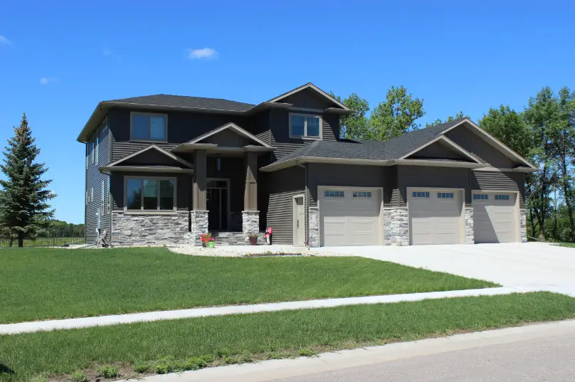 a house with a driveway and grass